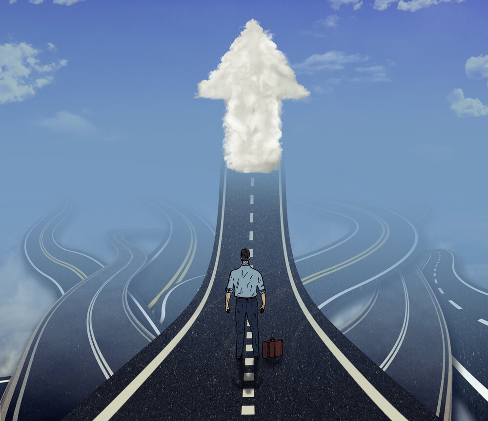 Career development business concept. Business man standing in front of many tangled roads with one highway leading up to arrow cloud as metaphor for leadership.-1