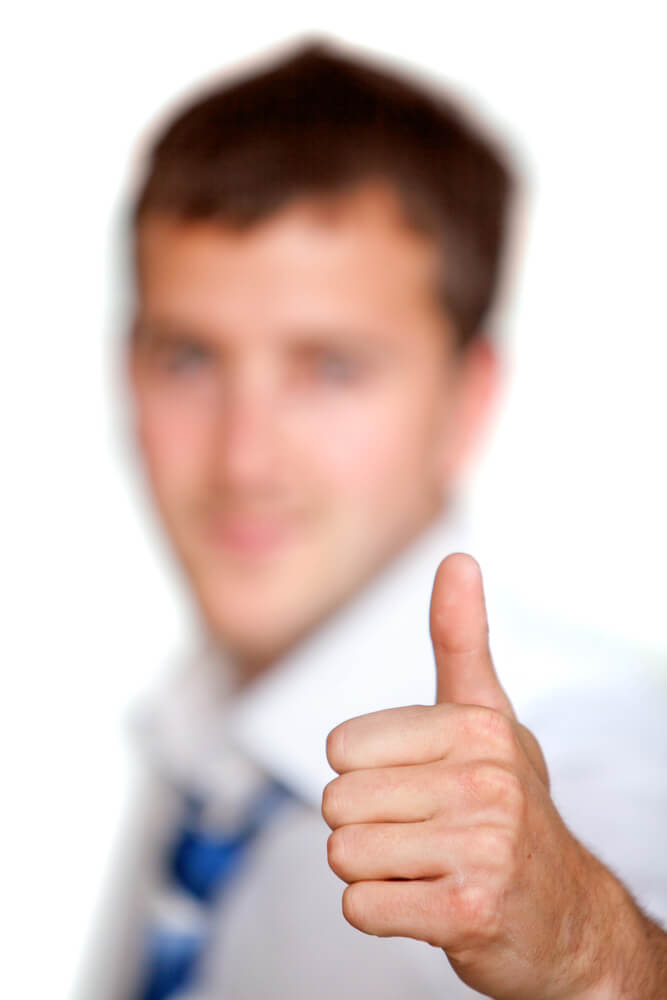 blurry young business man showing thumb up